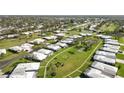 Wide aerial view showcases a neighborhood's well-manicured lawns and mature trees at 3220 Southfield Ln # 810, Sarasota, FL 34239