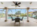 Inviting outdoor space featuring a screened-in pool with ample seating and a picturesque golf course view at 934 Rotonda Cir, Rotonda West, FL 33947