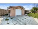 Attached garage with a white door and ample parking space at 5810 8Th Ave, New Port Richey, FL 34652