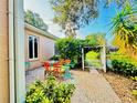 Outdoor patio with seating area, lush landscaping, and a view of a canal at 1108 Bayhead Ln, Osprey, FL 34229