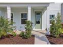 Charming front porch with elegant columns and verdant landscaping at 9039 Duany Ln, Lakewood Ranch, FL 34240