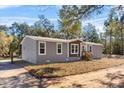 Charming single Gathering home featuring gray siding and complemented by lush surrounding trees at 2044 Culbreath Rd, Brooksville, FL 34601