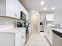 Modern kitchen with white cabinets, stainless steel appliances, and quartz countertops at 24692 Rio Villa Lakes Cir, Punta Gorda, FL 33950