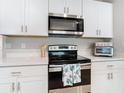 Close-up of kitchen range and microwave at 24692 Rio Villa Lakes Cir, Punta Gorda, FL 33950