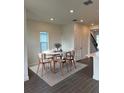 Bright dining area with round table, six chairs, and neutral decor at 9019 Rothman Ln, Lakewood Ranch, FL 34240