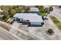 Aerial view of a single story home with a large yard and surrounding houses at 8701 Gulf Blvd, St Pete Beach, FL 33706