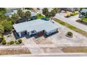 Aerial view of a single-story home with a spacious yard and palm trees at 8701 Gulf Blvd, St Pete Beach, FL 33706