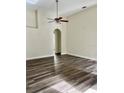 Spacious living room with hardwood floors and an arched doorway at 1652 Open Field Loop, Brandon, FL 33510