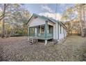 White sided home with green accents and a spacious porch at 11317 Salina St, Brooksville, FL 34614