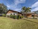 View of house's side, showcasing tan walls and brown accents at 1700 Curry Trl # 35, Nokomis, FL 34275