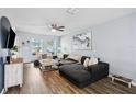 Living room with L-shaped sofa, coffee table, and wood-look floors at 27096 Wakefield Dr, Brooksville, FL 34602