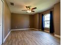 Bright bedroom with wood-look tile floors and a large window at 4154 Duluth Ter, North Port, FL 34286