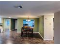 Bright dining area with wood flooring and modern light fixture at 7848 Teal Dr, New Port Richey, FL 34653