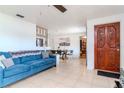 Living room with blue sofa, wood dining table, and decorative wall at 4760 84Th N Ter, Pinellas Park, FL 33781