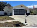 Exterior view of the house, showing the garage and driveway at 11422 Brown Bear Ln, Port Richey, FL 34668