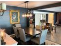 Elegant dining room with dark wood table and chairs, and stylish light fixture at 2695 68Th S Ave, St Petersburg, FL 33712