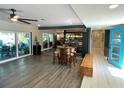 Open living area with wood-look floors, a built-in bench, and access to a patio at 2695 68Th S Ave, St Petersburg, FL 33712