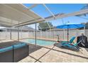 Inviting screened-in pool with brick paver deck, sun loungers, and cozy seating area at 11143 Rising Mist Blvd, Riverview, FL 33578