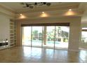 Bright living room featuring tiled floors, a fireplace, and a view of the pool through sliding glass doors at 24289 Toth Ln, Punta Gorda, FL 33955