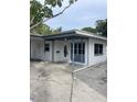 White single story house with covered entryway and a carport at 3967 Arkansas Ne Ave, St Petersburg, FL 33703