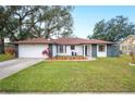 Beautiful house with a red tile roof, white exterior, and stone accents at 1413 Sandalwood Dr, Plant City, FL 33563