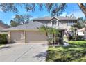 Two-story house, three car garage, and manicured lawn at 3507 Autumn Glen Dr, Valrico, FL 33596