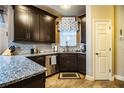 Modern kitchen with dark cabinetry, granite counters, and stainless steel appliances at 2211 Preservation Dr # 2211, Plant City, FL 33566