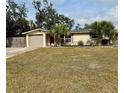 House with a spacious lawn and a two-car garage at 122 Gulf Breeze Blvd, Venice, FL 34293