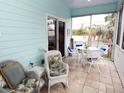 Relaxing screened porch with wicker furniture offers a comfortable outdoor seating area at 130 Bay Plz, Treasure Island, FL 33706