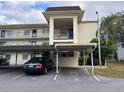 Condo building with covered parking at 1415 Doolittle Ln # 107, Dunedin, FL 34698