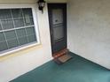 Condo unit entrance with screen door at 1415 Doolittle Ln # 107, Dunedin, FL 34698