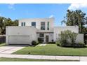 Contemporary two-story home with attached garage and neat landscaping at 3110 W Napoleon Ave, Tampa, FL 33611