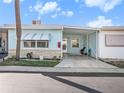 Front view of a light blue house with carport at 250 Rosery Nw Rd # 260, Largo, FL 33770