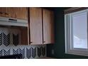 Wood cabinets and a window above the kitchen counter at 39132 County Road 54 # 2216, Zephyrhills, FL 33542