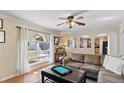 Cozy living room featuring a large window, archways, neutral paint, and a ceiling fan at 19245 Wood Sage Dr, Tampa, FL 33647