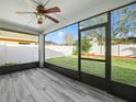 Screened porch with wood-look tile floor and view of backyard at 4512 Preston Woods Dr, Valrico, FL 33596