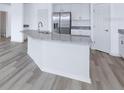 Modern kitchen island with granite countertops and white cabinets at 6068 Ballast Dr, Wimauma, FL 33598