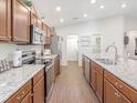 Spacious kitchen with stainless steel appliances and light wood cabinets at 6081 Ballast Dr, Wimauma, FL 33598