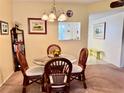 Simple dining area with glass table and wicker chairs at 936 Virginia St # 208, Dunedin, FL 34698