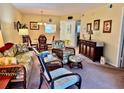 Bright and airy living room with a dining area and wicker furniture at 936 Virginia St # 208, Dunedin, FL 34698