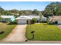 Charming single Gathering home featuring a well-maintained front lawn and a two car garage at 2167 Timber Ln, Clearwater, FL 33763