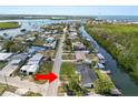 Aerial view of home located along canal featuring a large body of water and residential neighborhood at 3215 W Shell Point Rd, Ruskin, FL 33570