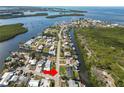 Aerial view of home on canal near large body of water with many boats and residential areas at 3215 W Shell Point Rd, Ruskin, FL 33570