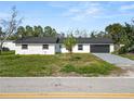 Charming single story home with a gray two car garage and well-manicured lawn at 3215 W Shell Point Rd, Ruskin, FL 33570