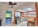 Charming kitchen with stainless steel appliances, a butcher block countertop, and skylights at 1413 May St, Lutz, FL 33548