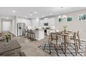 Bright kitchen boasts an island with seating, stainless steel appliances, and adjacent dining area at 1970 Blackwood Cir, North Port, FL 34286
