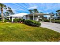 House with carport and manicured hedges at 266 Cerromar S Way # 55, Venice, FL 34293