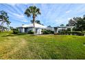 White house with palm tree and grassy yard at 266 Cerromar S Way # 55, Venice, FL 34293