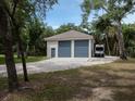 Detached two-car garage with gray doors and ample parking at 5515 Reisterstown Rd, North Port, FL 34291