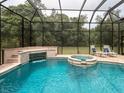 Inviting pool area with spa and screened enclosure at 5515 Reisterstown Rd, North Port, FL 34291